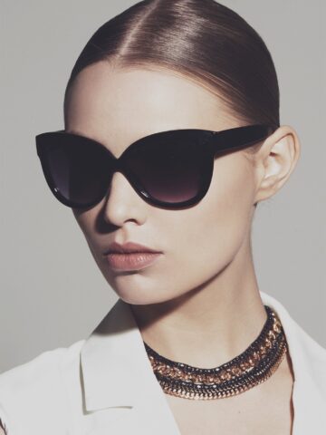 Wearing sleek black glasses