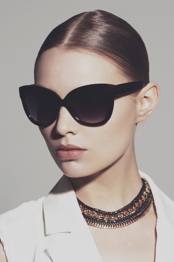 Wearing sleek black glasses